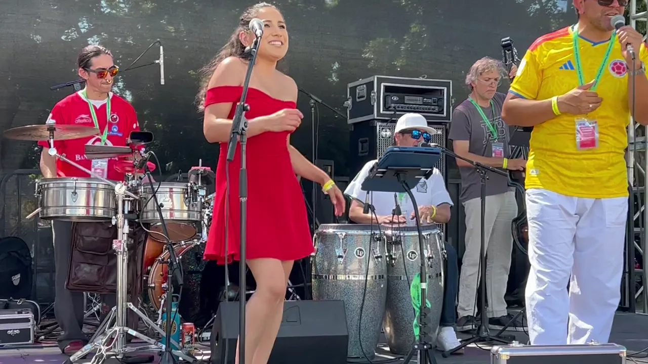 Latin band performing at the 2026 Camarillo Fiesta with microphones, monitors and backline on stage